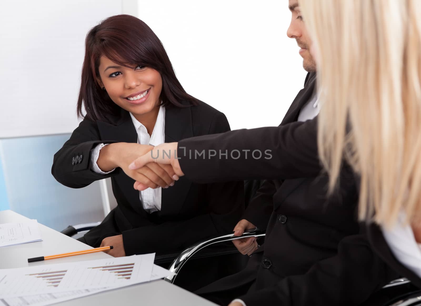 Businesspeople shaking hands in the meeting by AndreyPopov