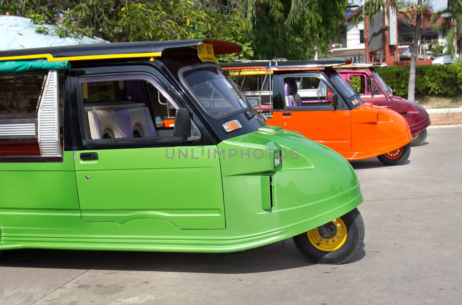 Tuk tuks lined up in a side ally in Thailand by sutipp11