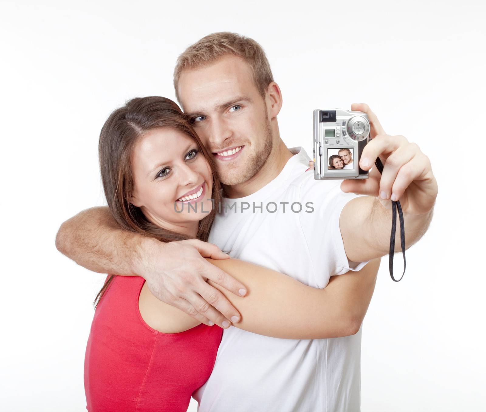happy young couple taking pictures of themselves - isolated on white