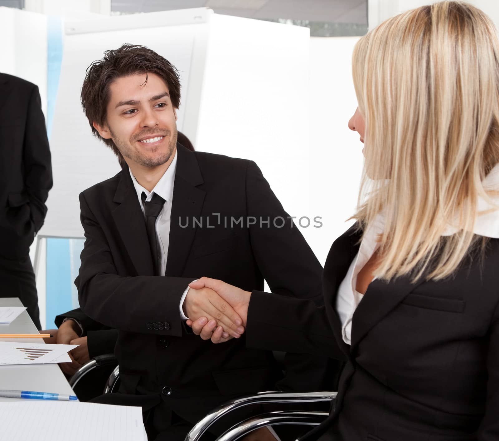 Successful businesspeople shaking hands in the meeting