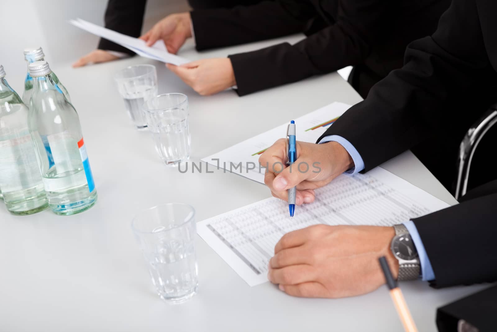 Group of business people taking notes at the meeting