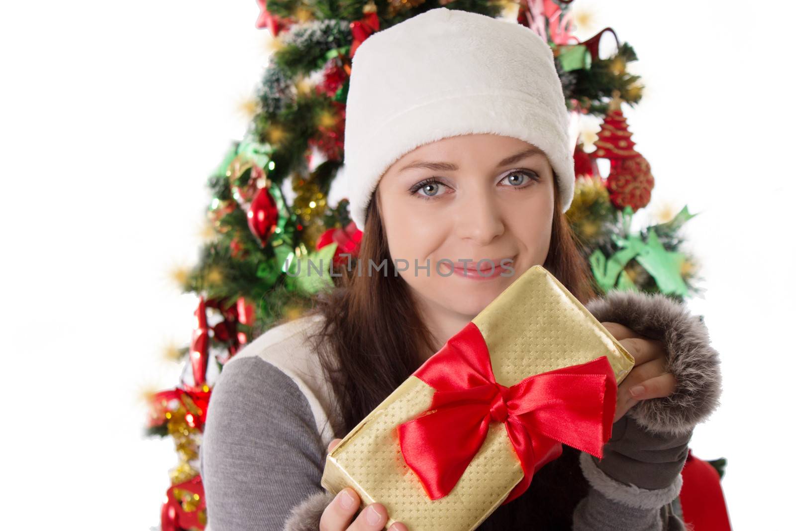 Smiling woman in fur hat and mitten holding Christmas present
