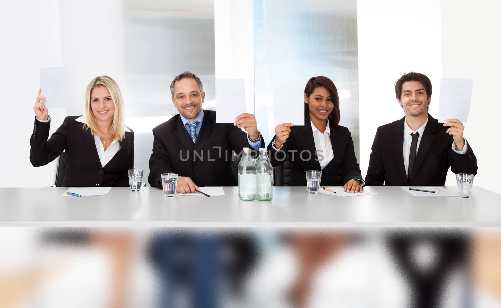 Group of panel judges holding empty score signs