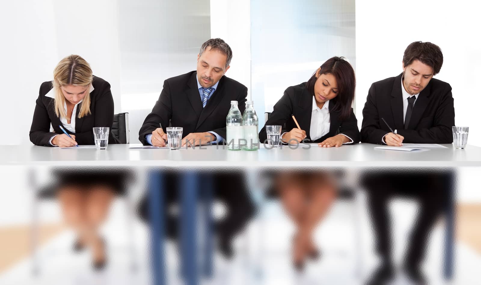 Group of business people taking notes at the meeting