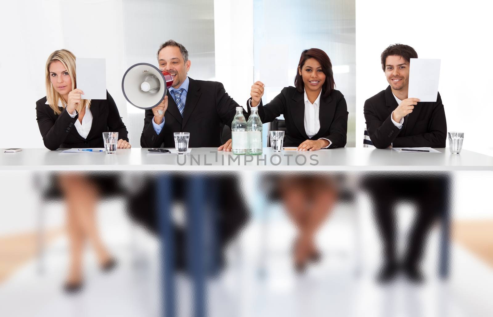 Group of panel judges holding empty score signs