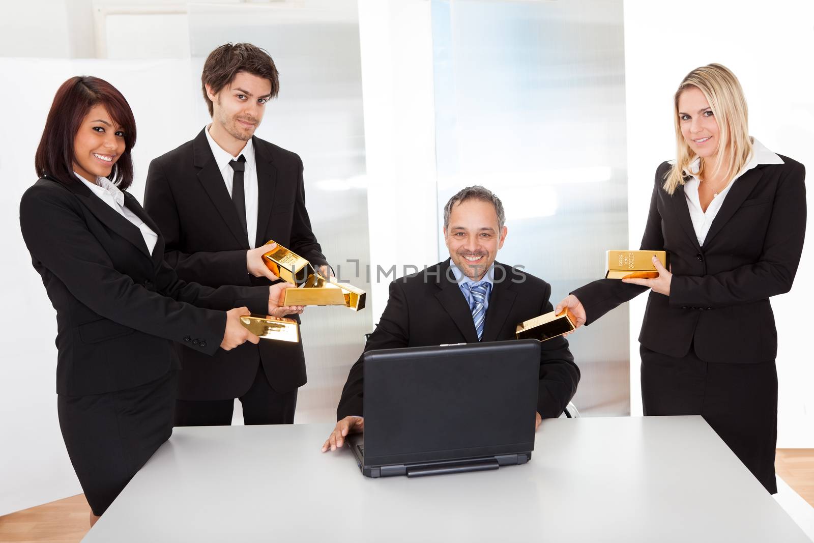 Portrait of happy businessman receiving gold bars