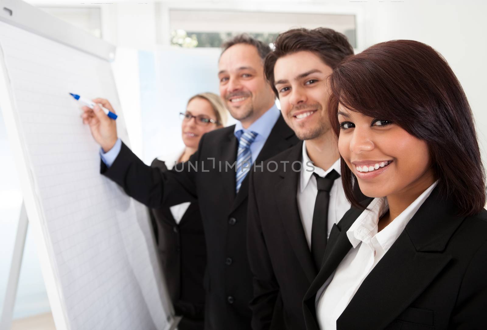 Group of business people looking at the graph on flipchart