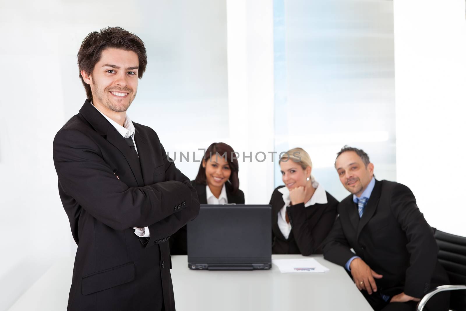 Portrait successful business man and his team