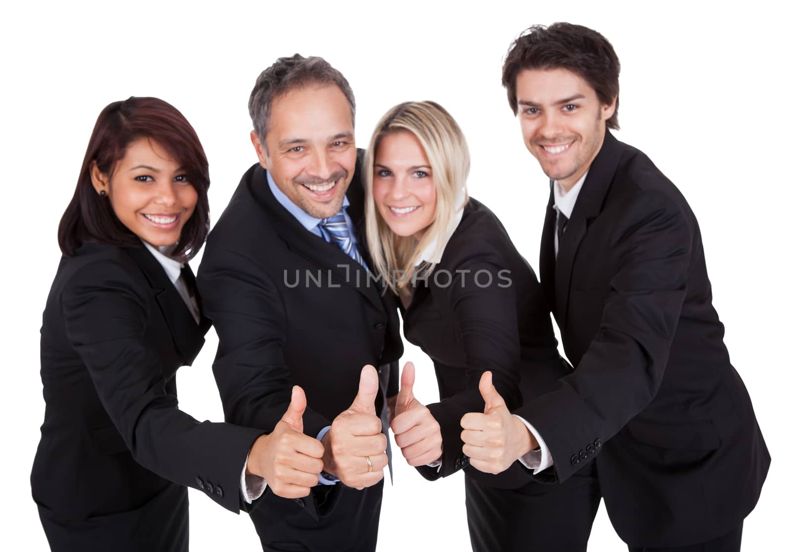 Happy business team celebrating a success with thumbs up on white background