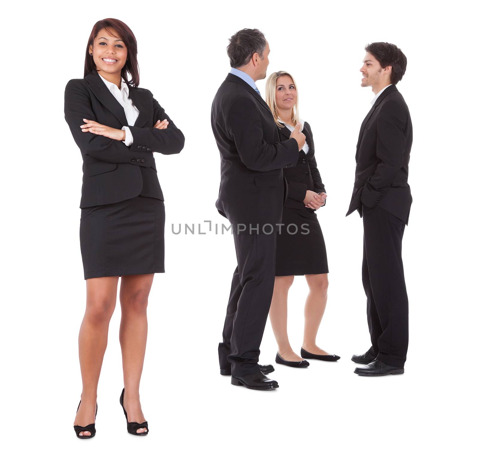 Confident businesswoman with successful group of business people on white background