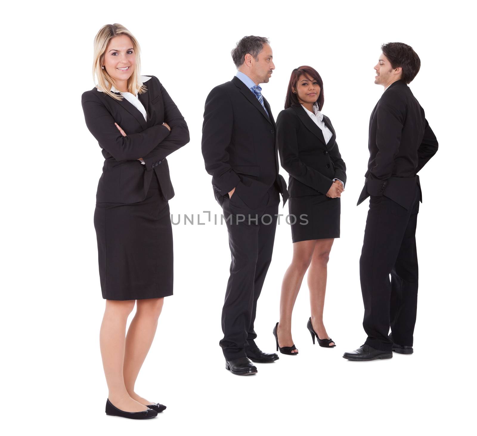 Confident businesswoman with successful group of business people on white background