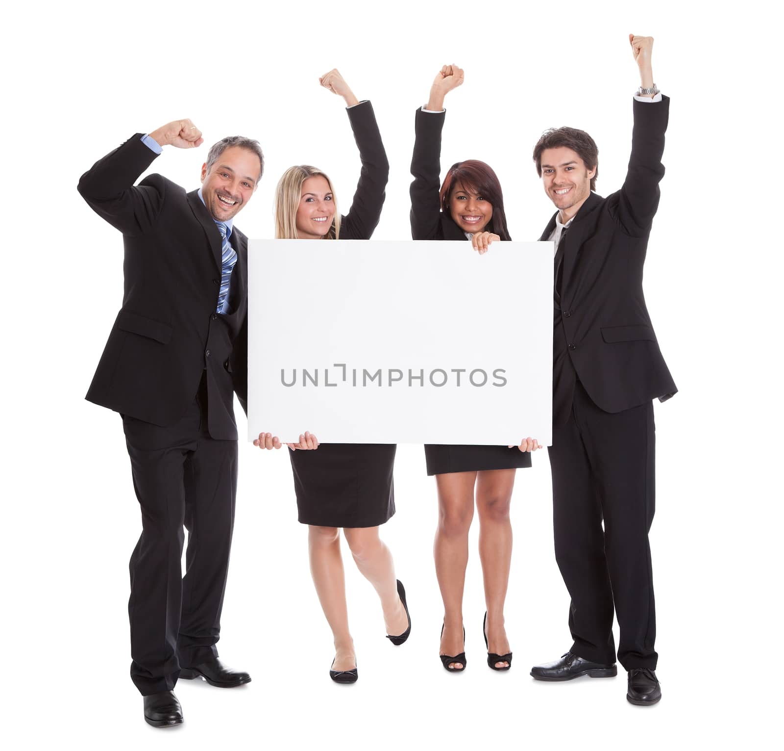 Group of happy business colleagues holding billboard isolated on white background