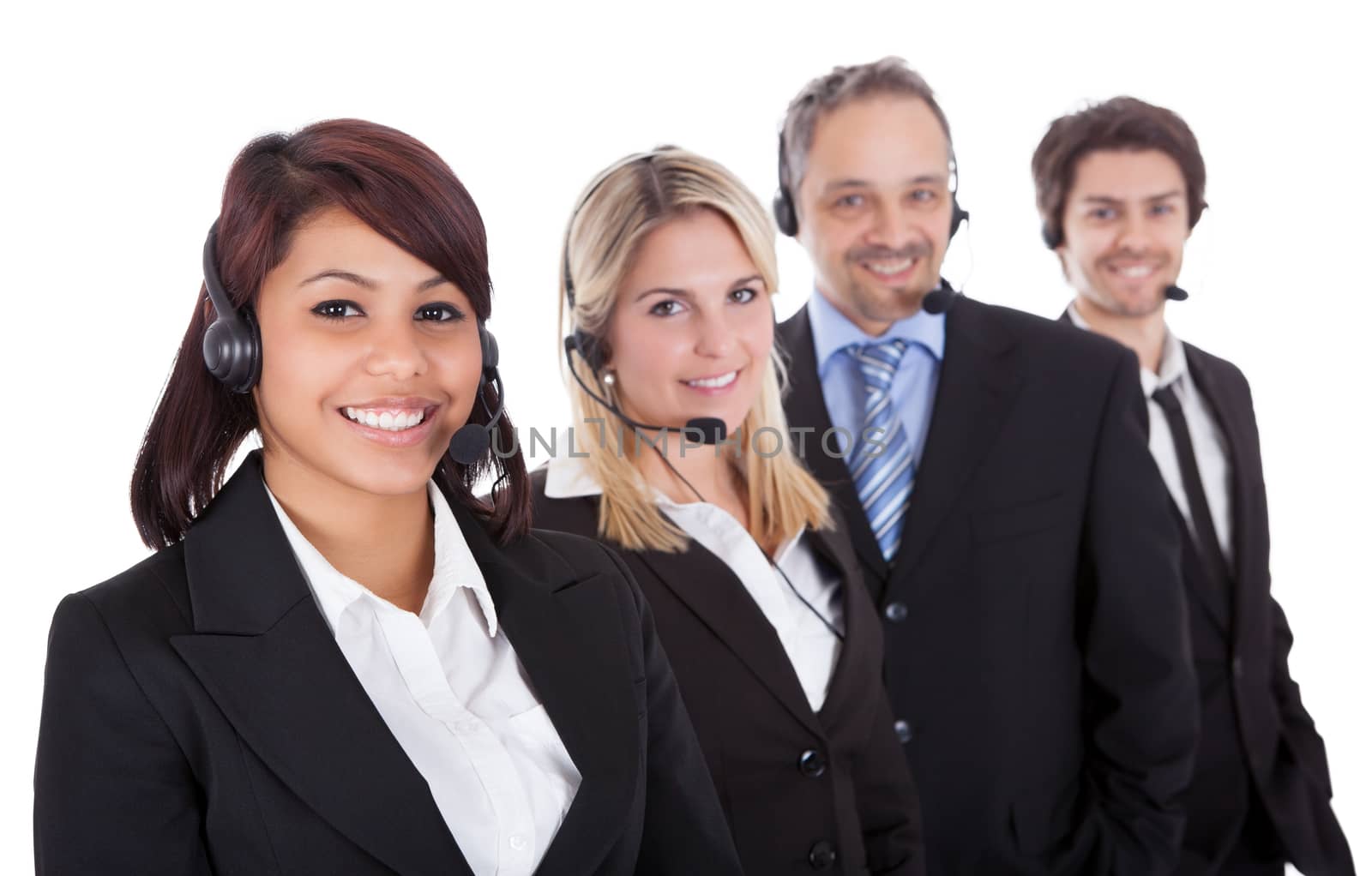 Confident business team with headset standing in a line against white background