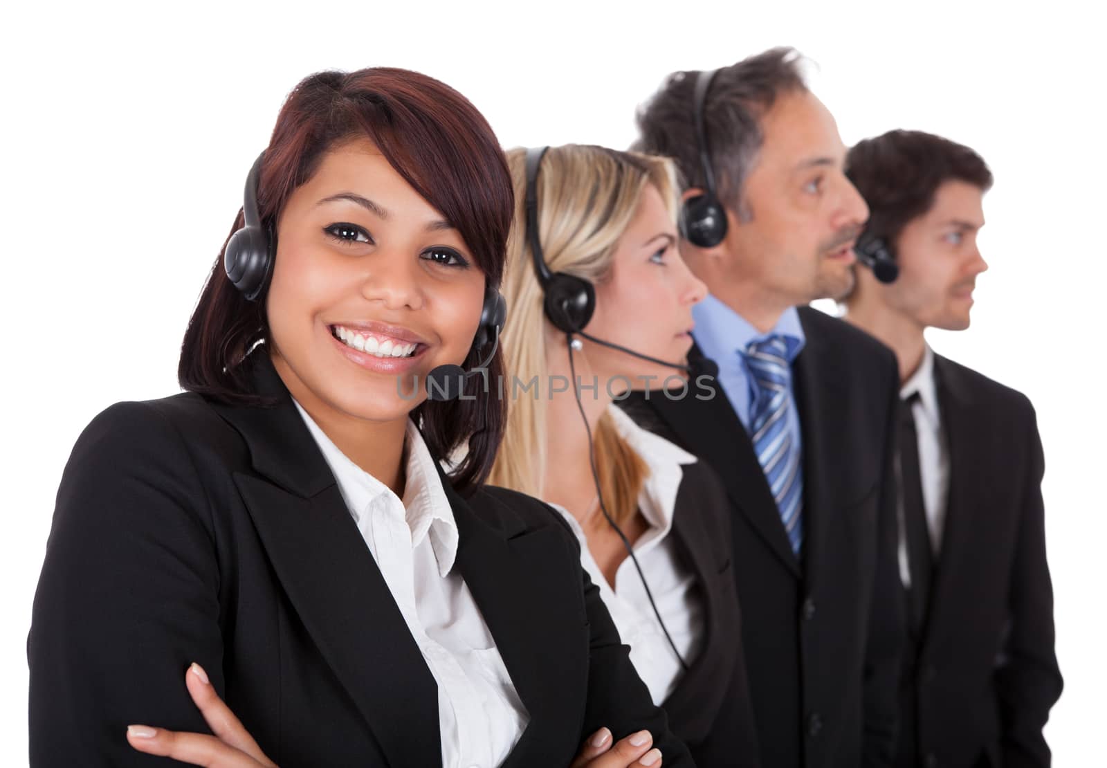 Confident business team with headset standing in a line against white background