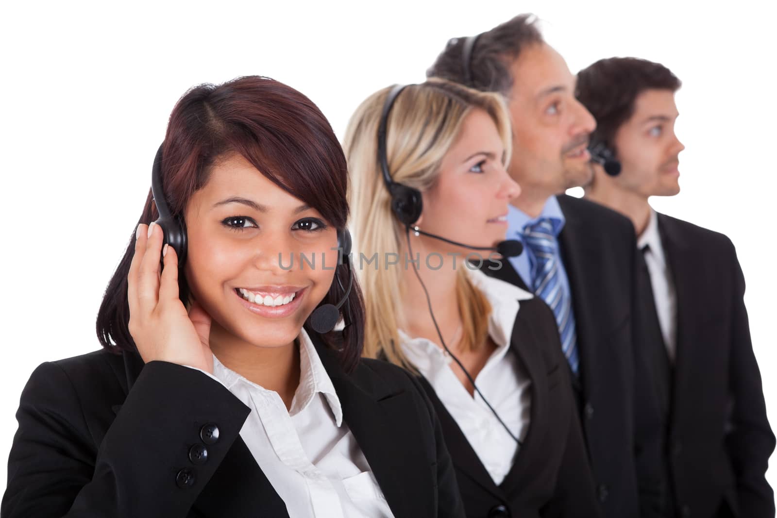 Confident business team with headset standing in a line against white background