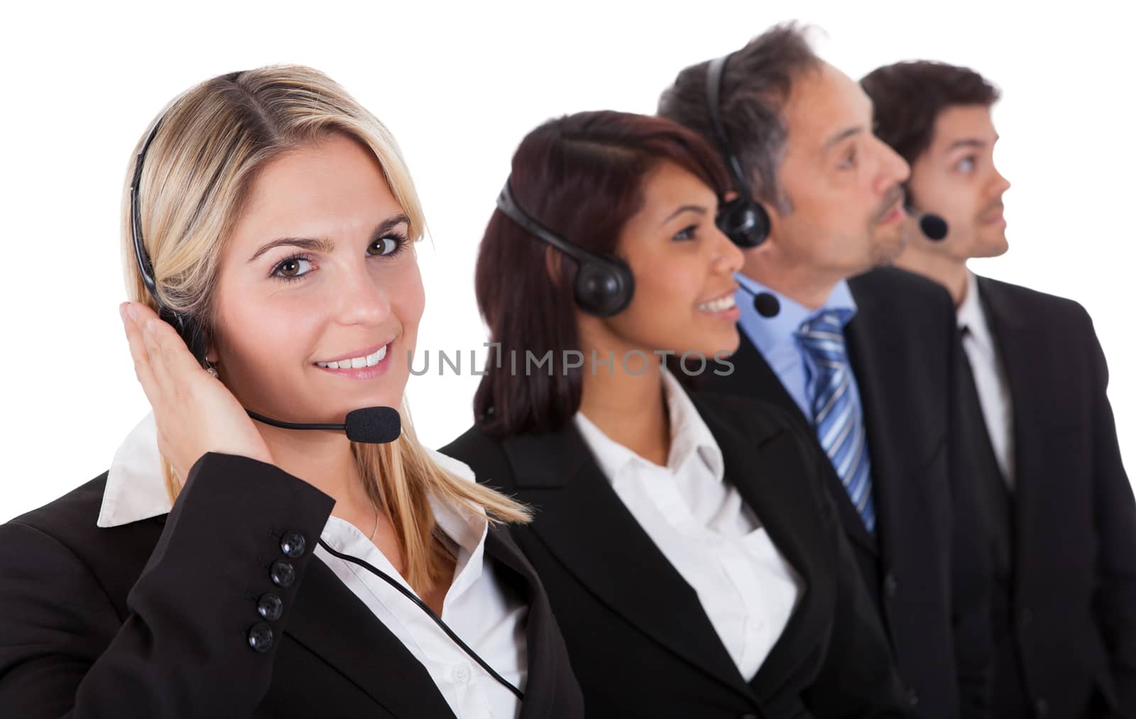 Confident business team with headset standing in a line against white background