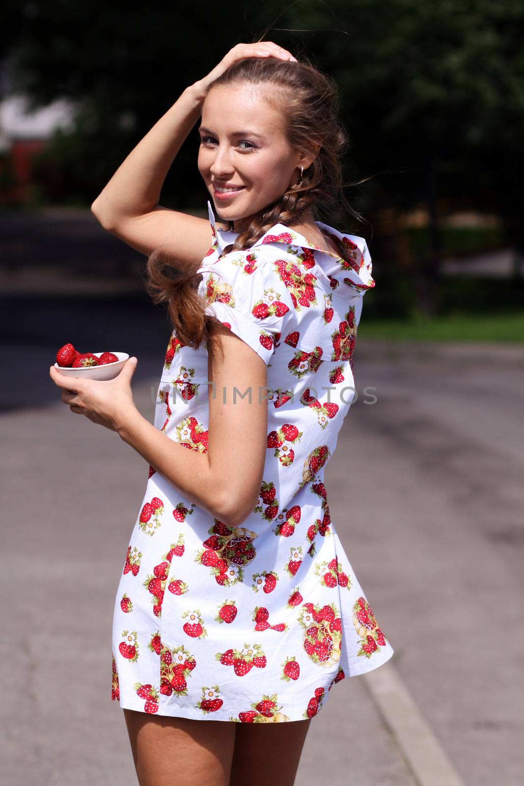 Portrait of the beautiful girl with a strawberry