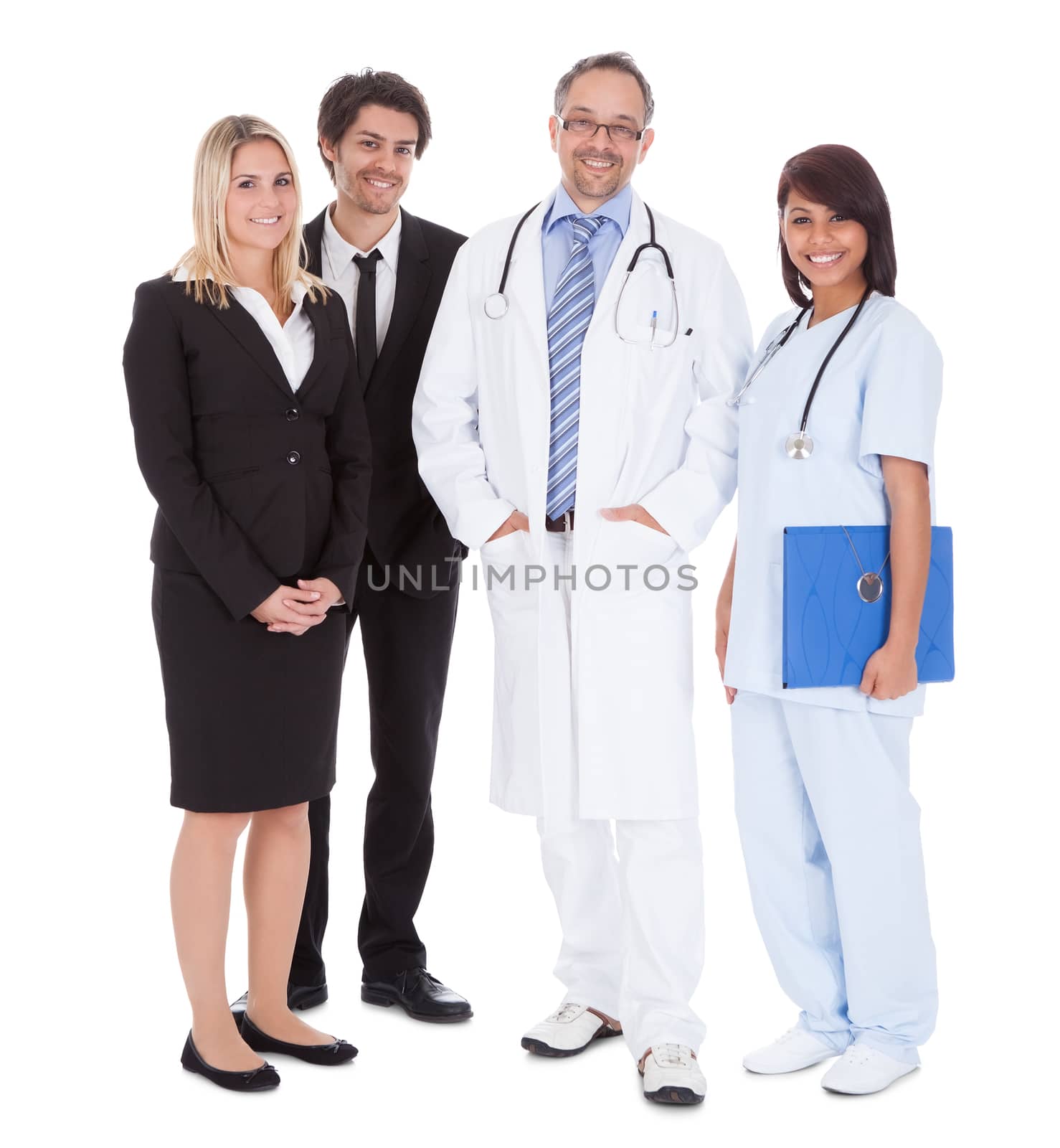 Portrait of businesspeople and medical workers standing on white background