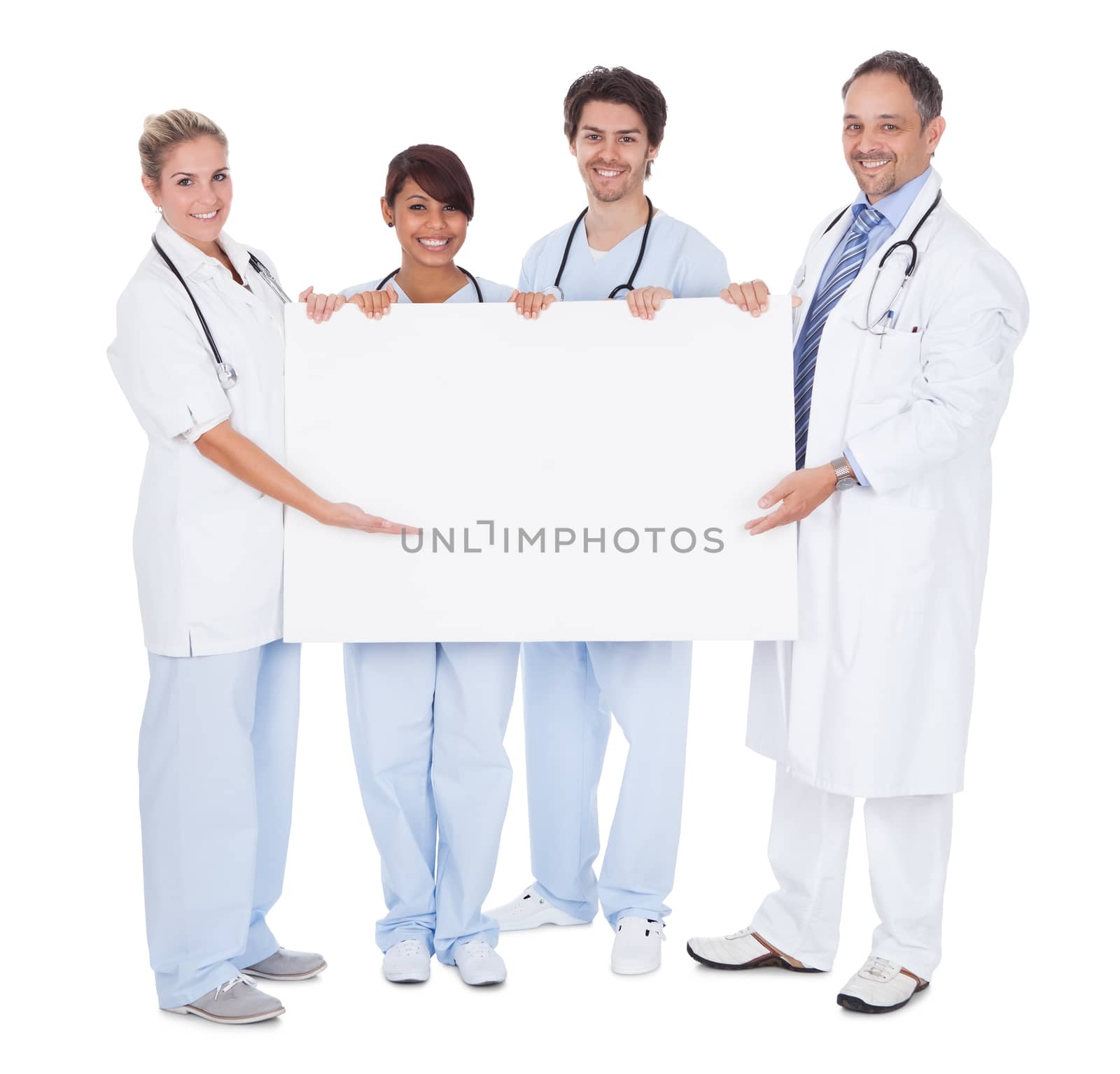 Group of doctors presenting empty board. Isolated on white