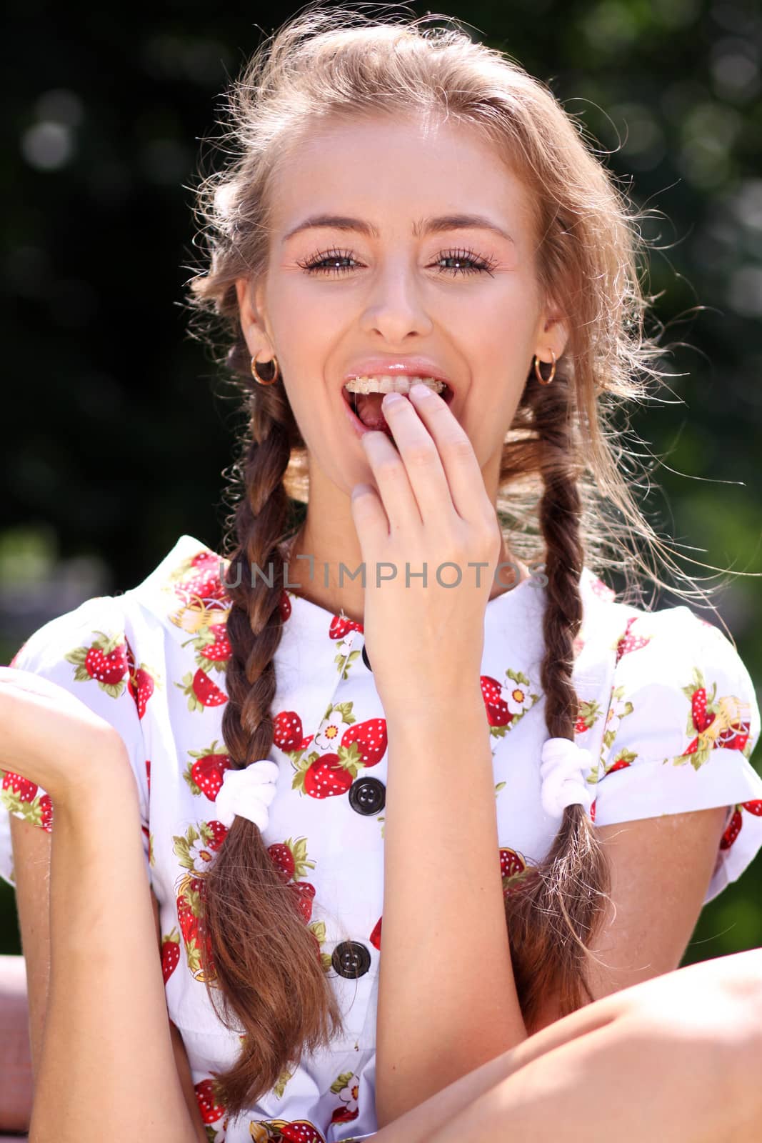 Portrait of the beautiful girl with a strawberry