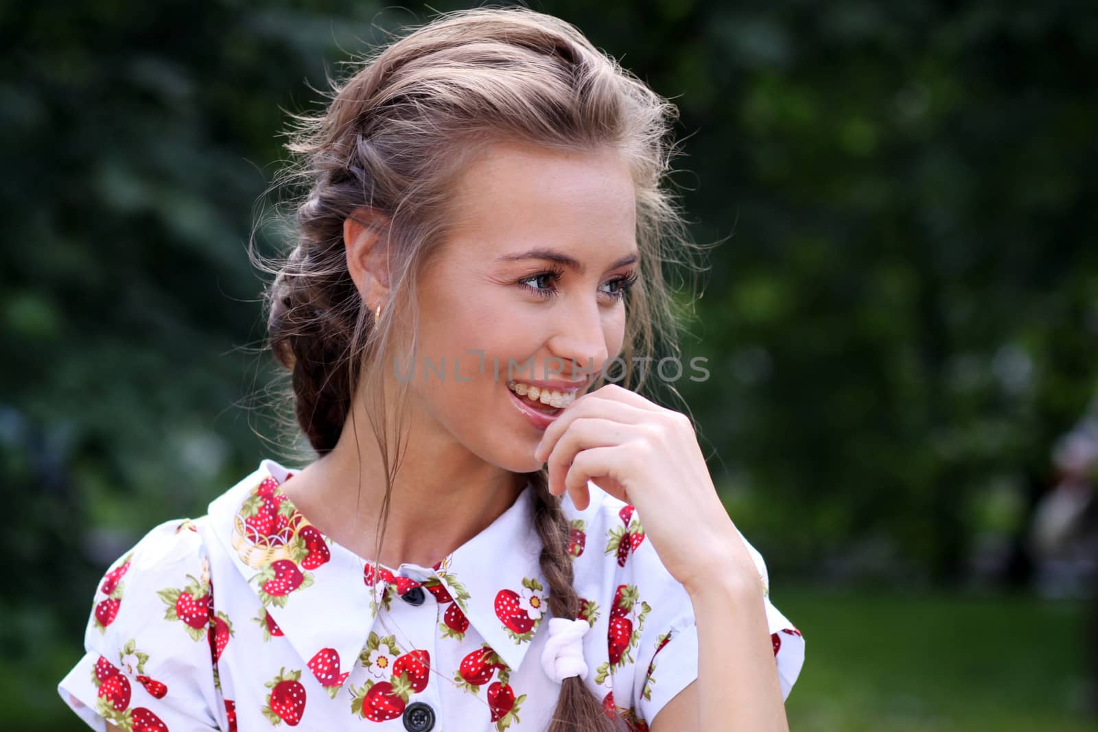 Portrait of the beautiful girl with a strawberry