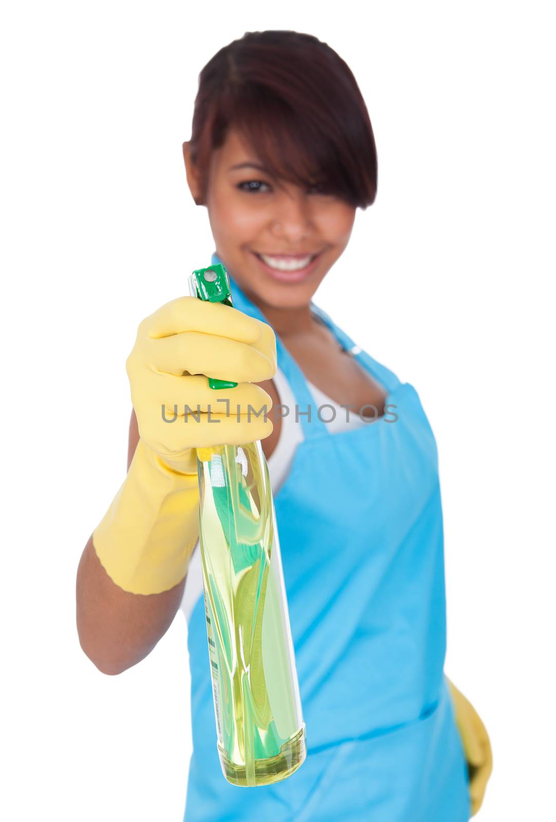 Cheerful young lady spraying cleaner liquid. Isolated on white