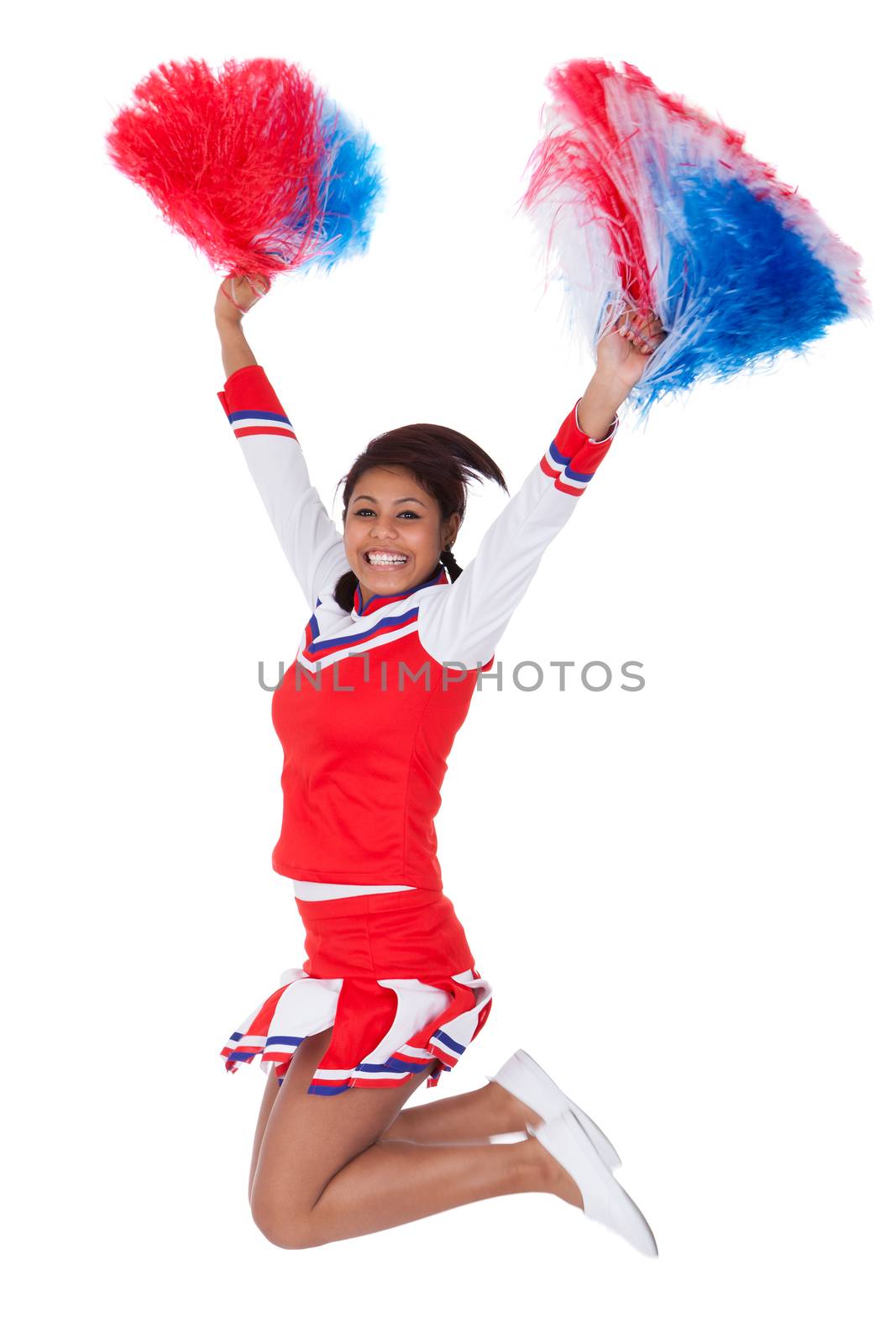 Smiling beautiful cheerleader with pompoms. Isolated on white