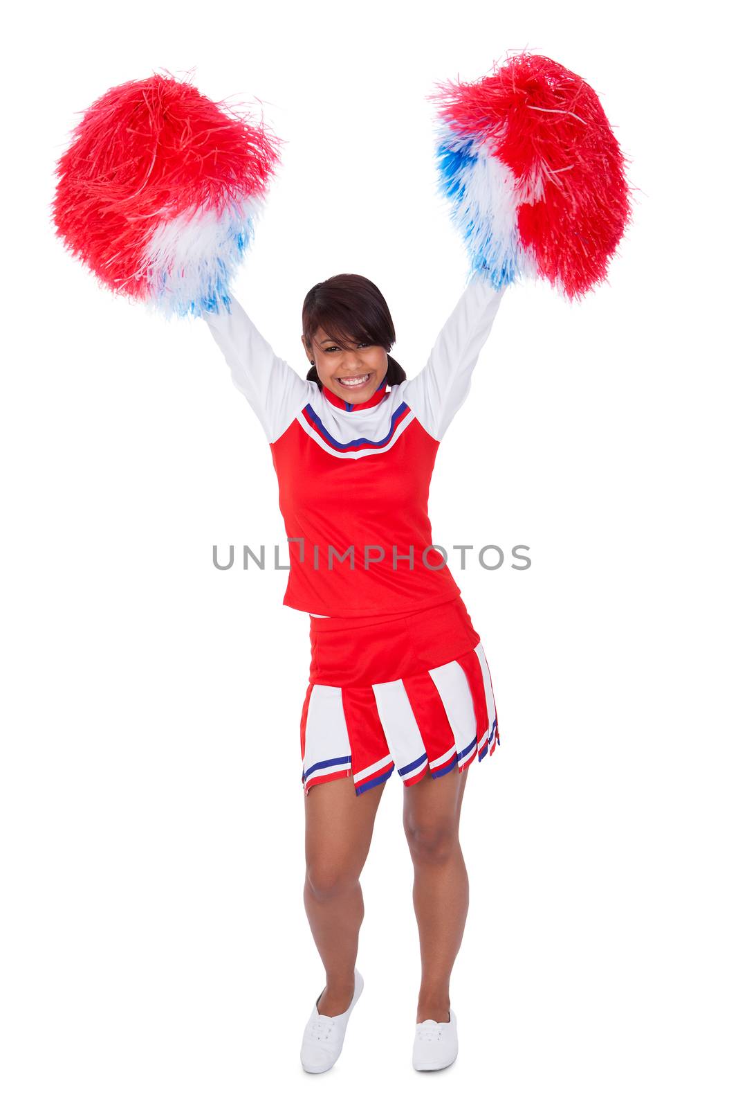 Smiling beautiful cheerleader with pompoms. Isolated on white