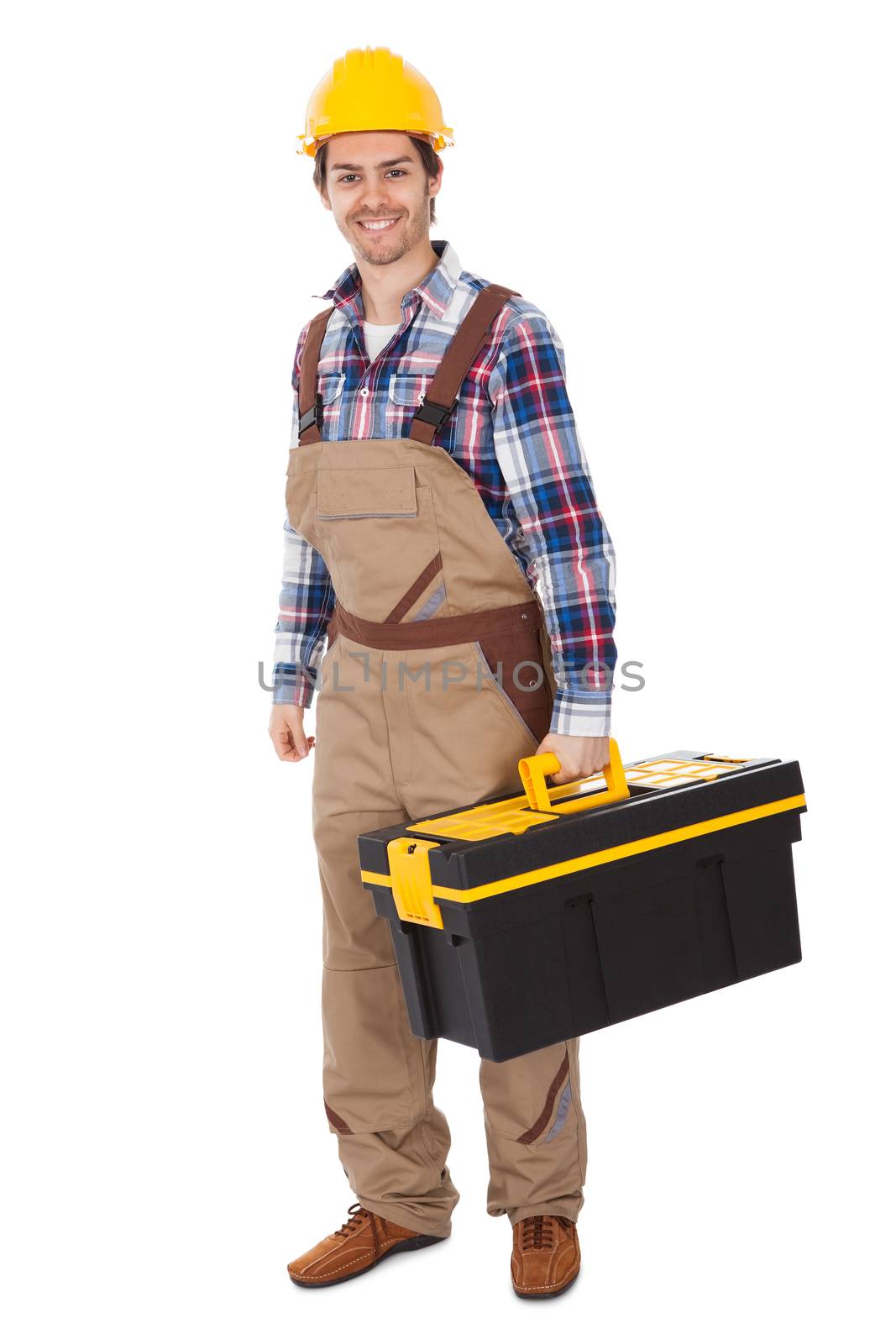 Confident repairman wearing hard hat and holding toolbox. Isolated on white