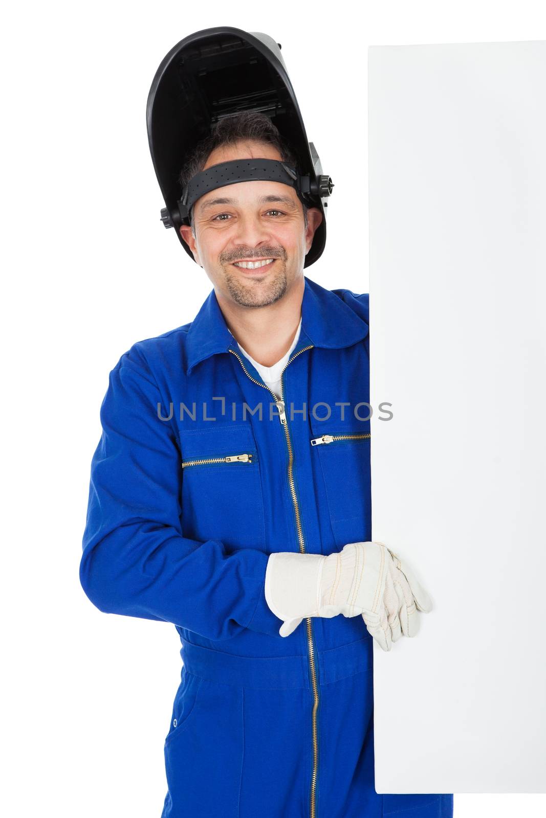 Portrait of confident welder presenting empty board. Isolated on white