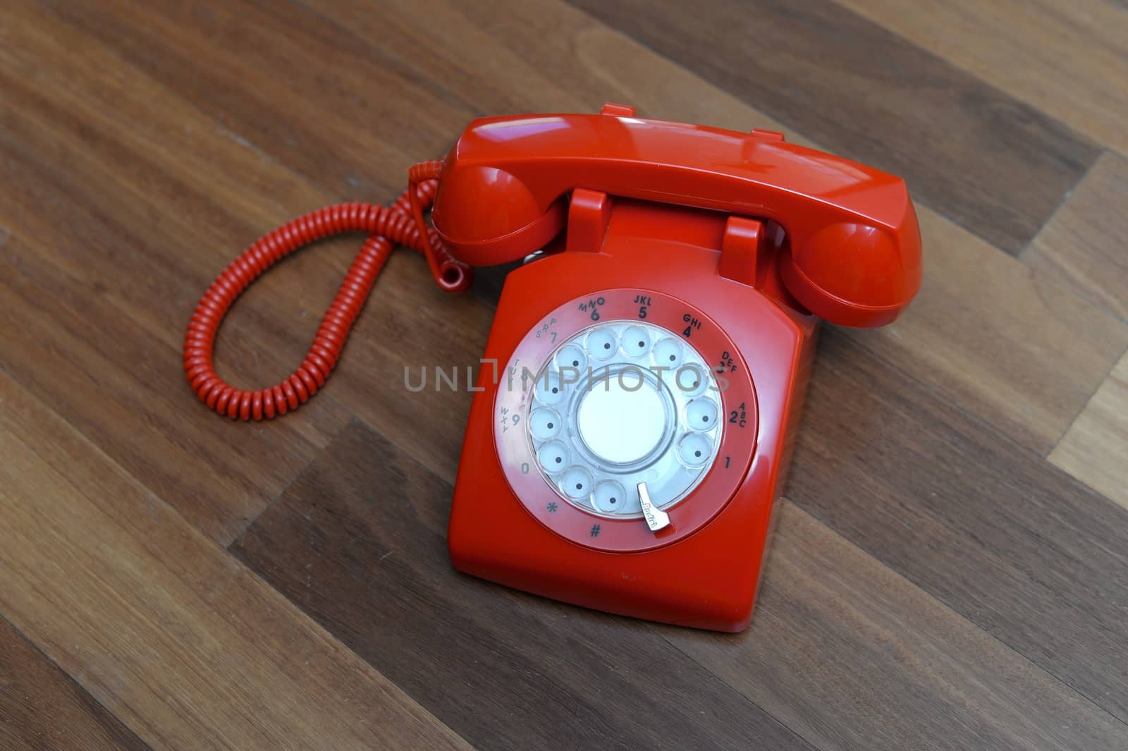 A vintage telephone isolated on a wooden floor