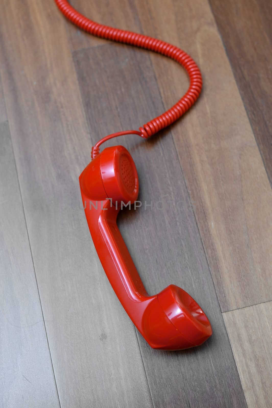 A vintage telephone isolated on a wooden floor