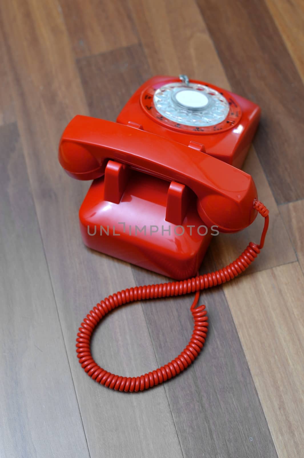 A vintage telephone isolated on a wooden floor