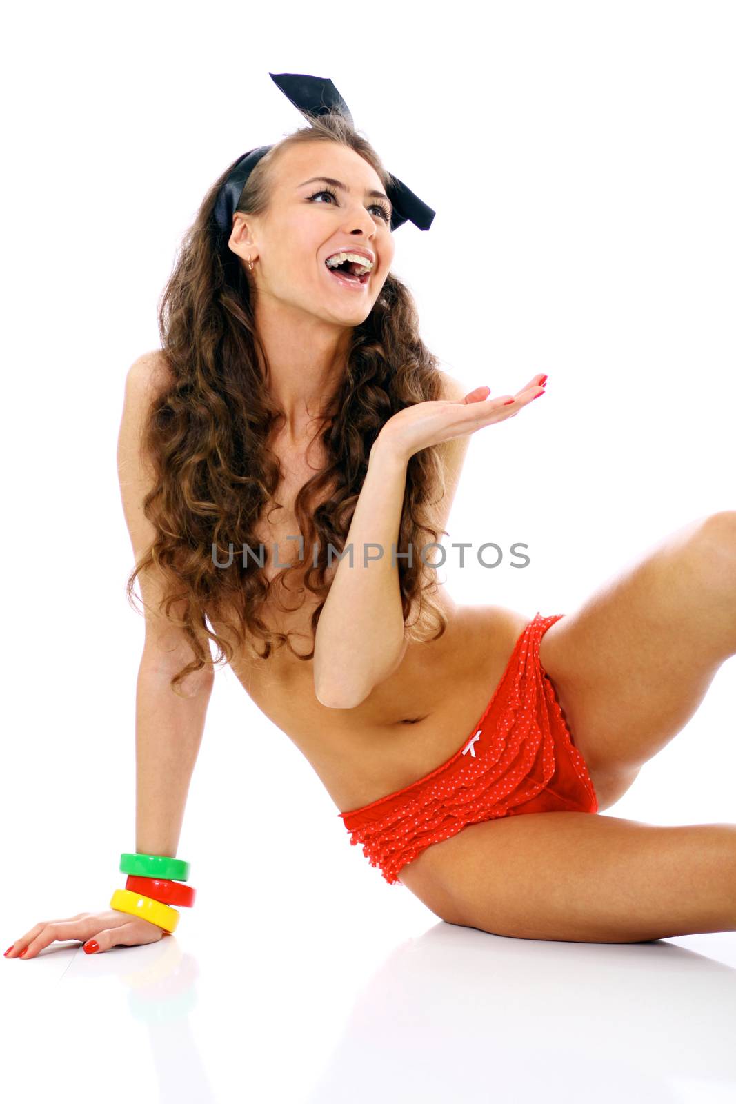 Beautiful topless young woman in red shorts