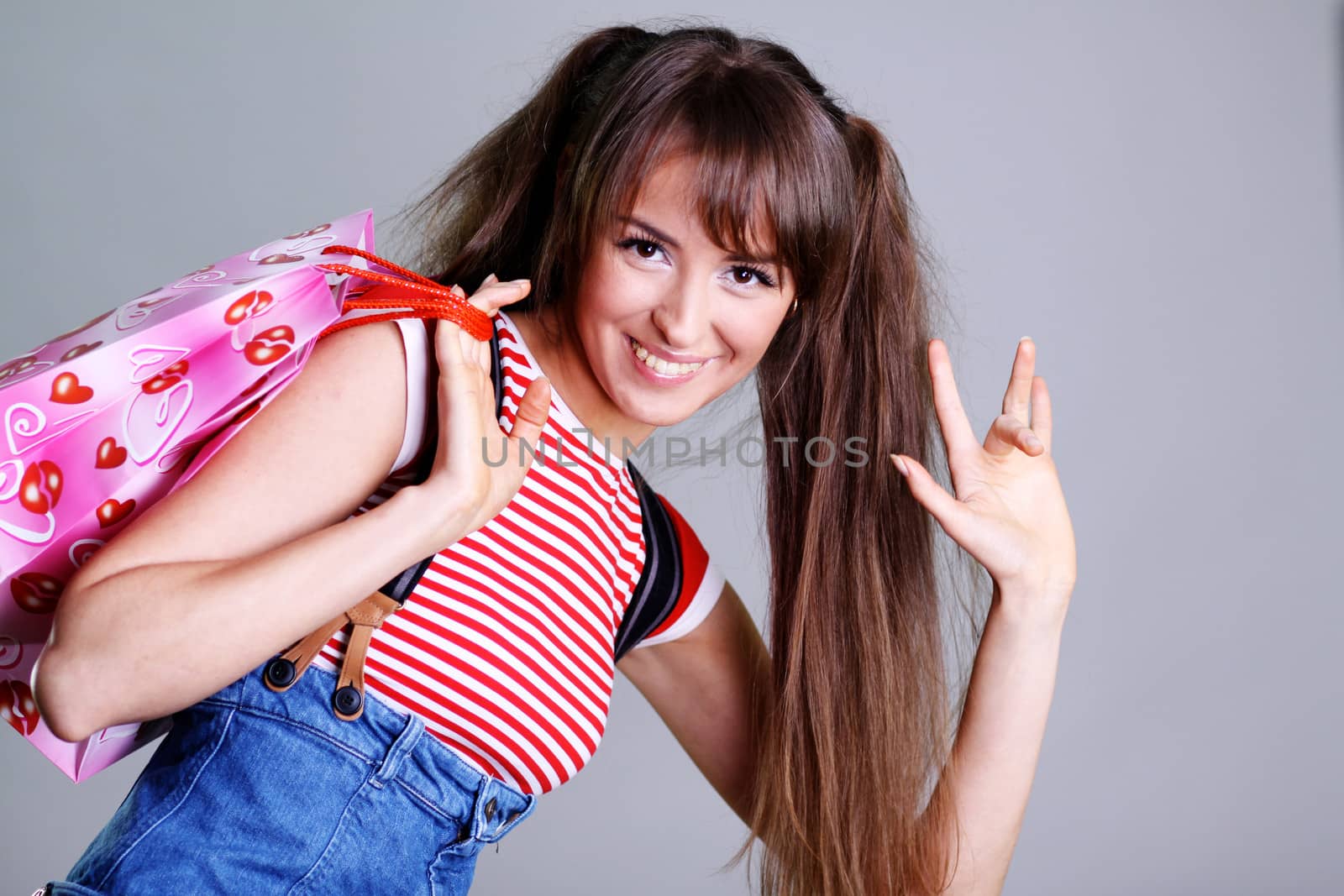 Beautiful young woman in gray background