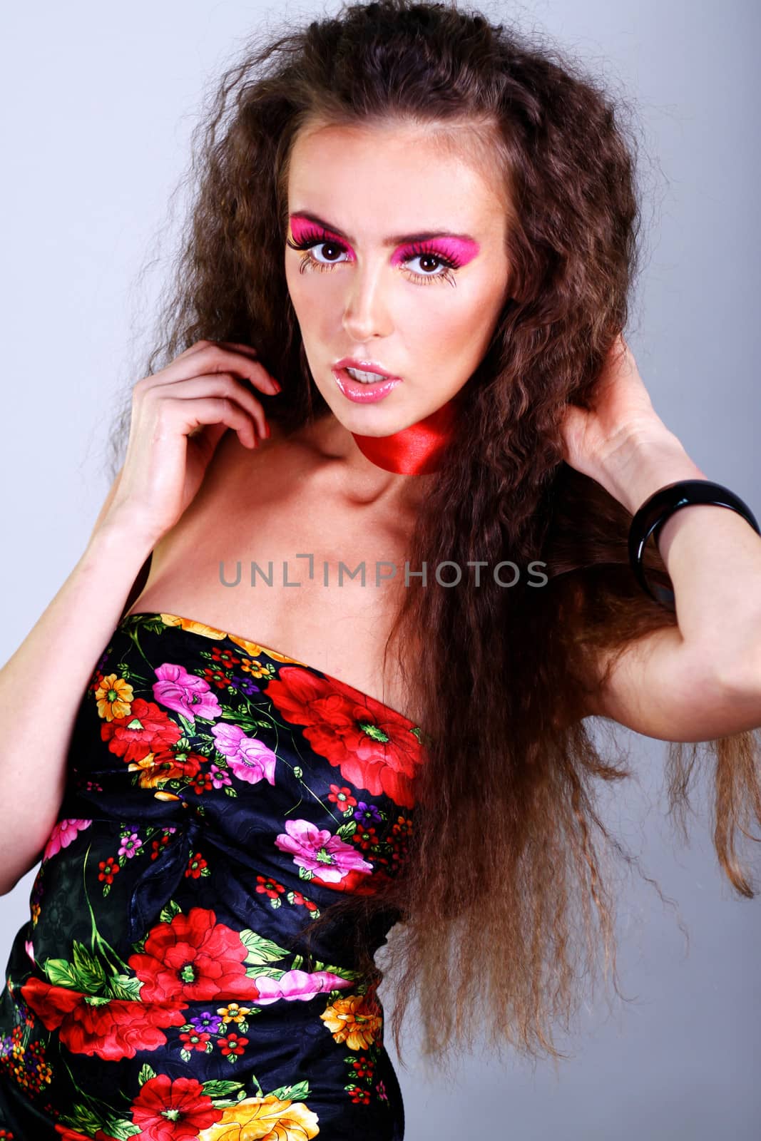 Beautiful young woman in gray background