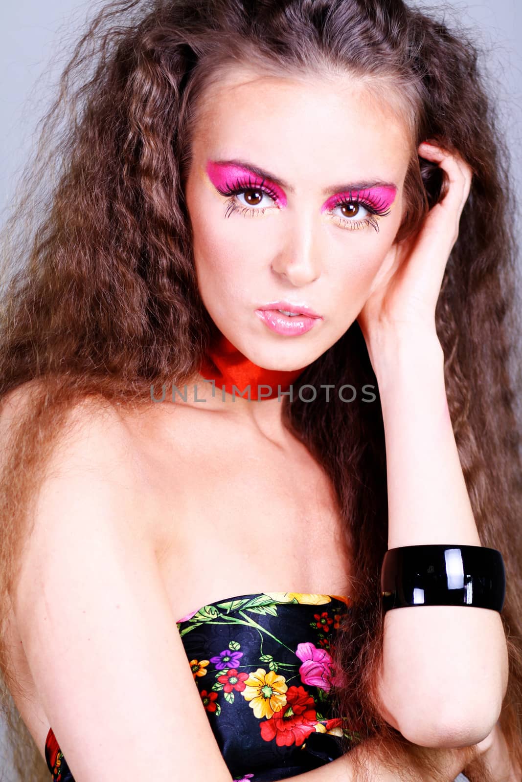 Beautiful young woman in gray background