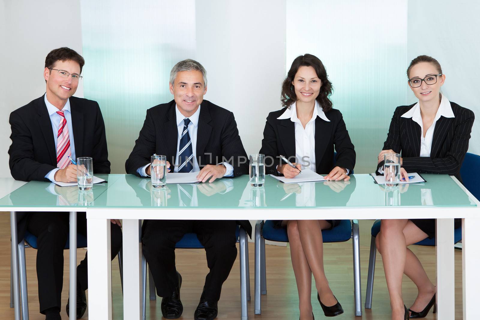 Panel of corporate personnel officers sitting at a table