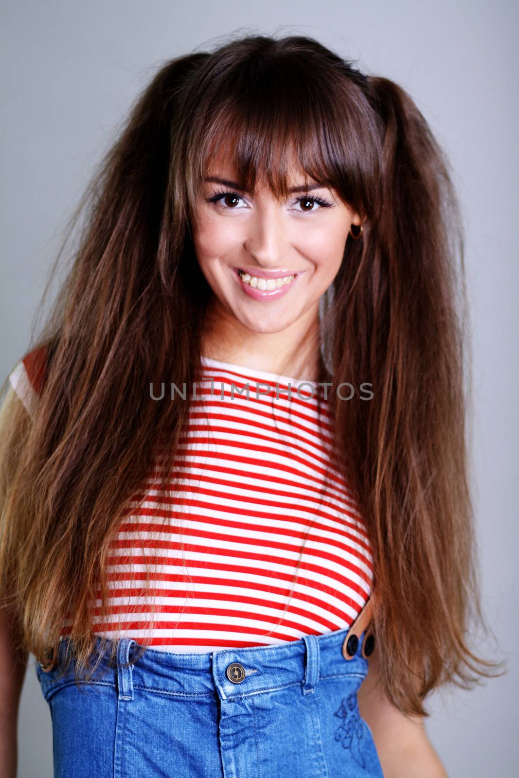 Beautiful young woman in gray background