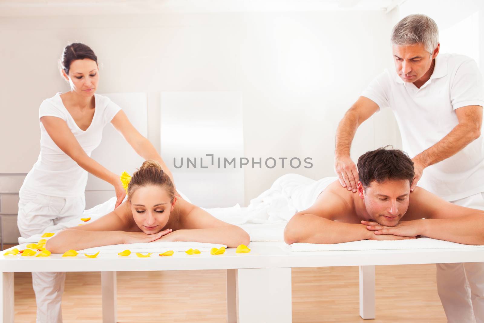 Masseurs giving back massages by AndreyPopov