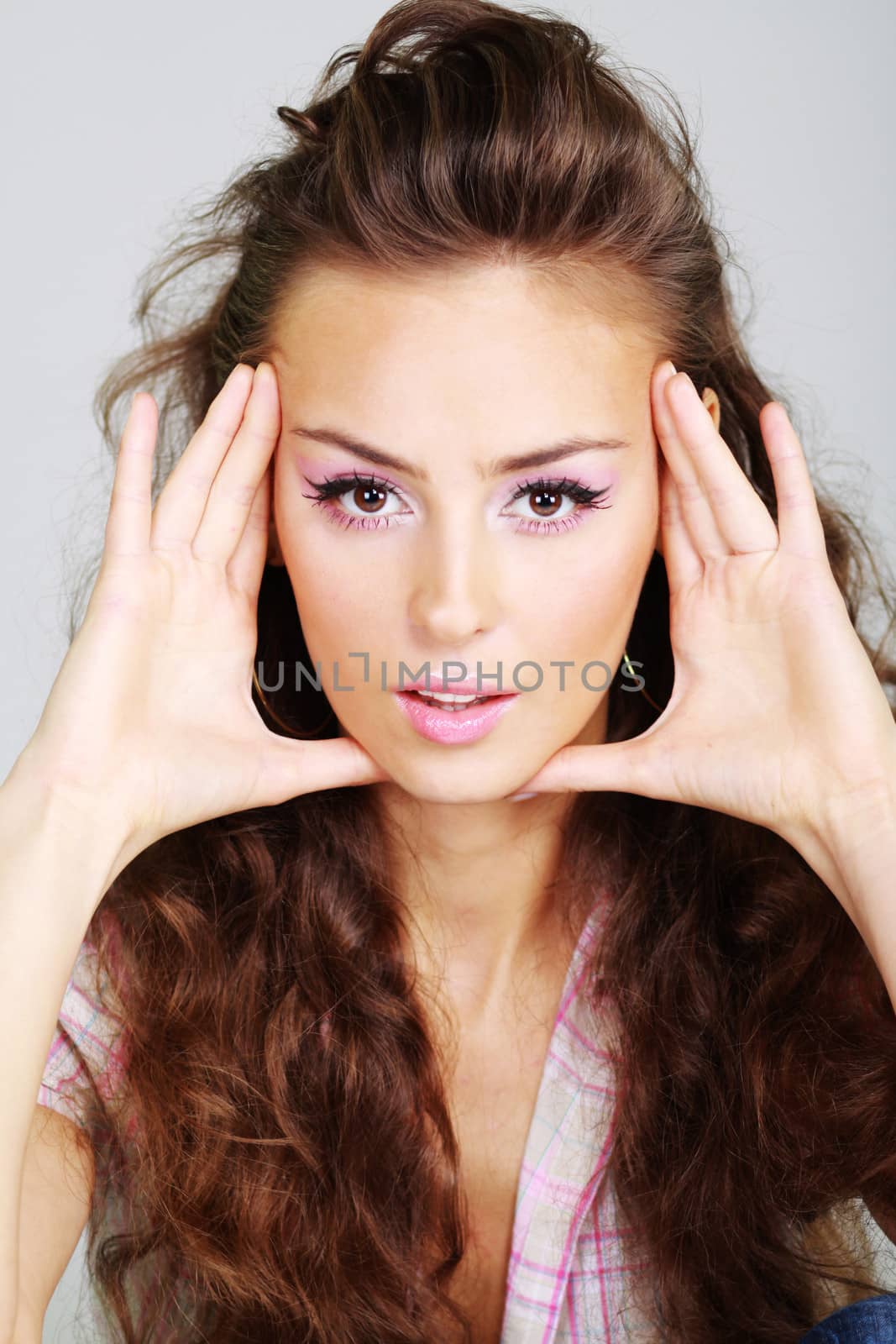 Beautiful young woman in gray background