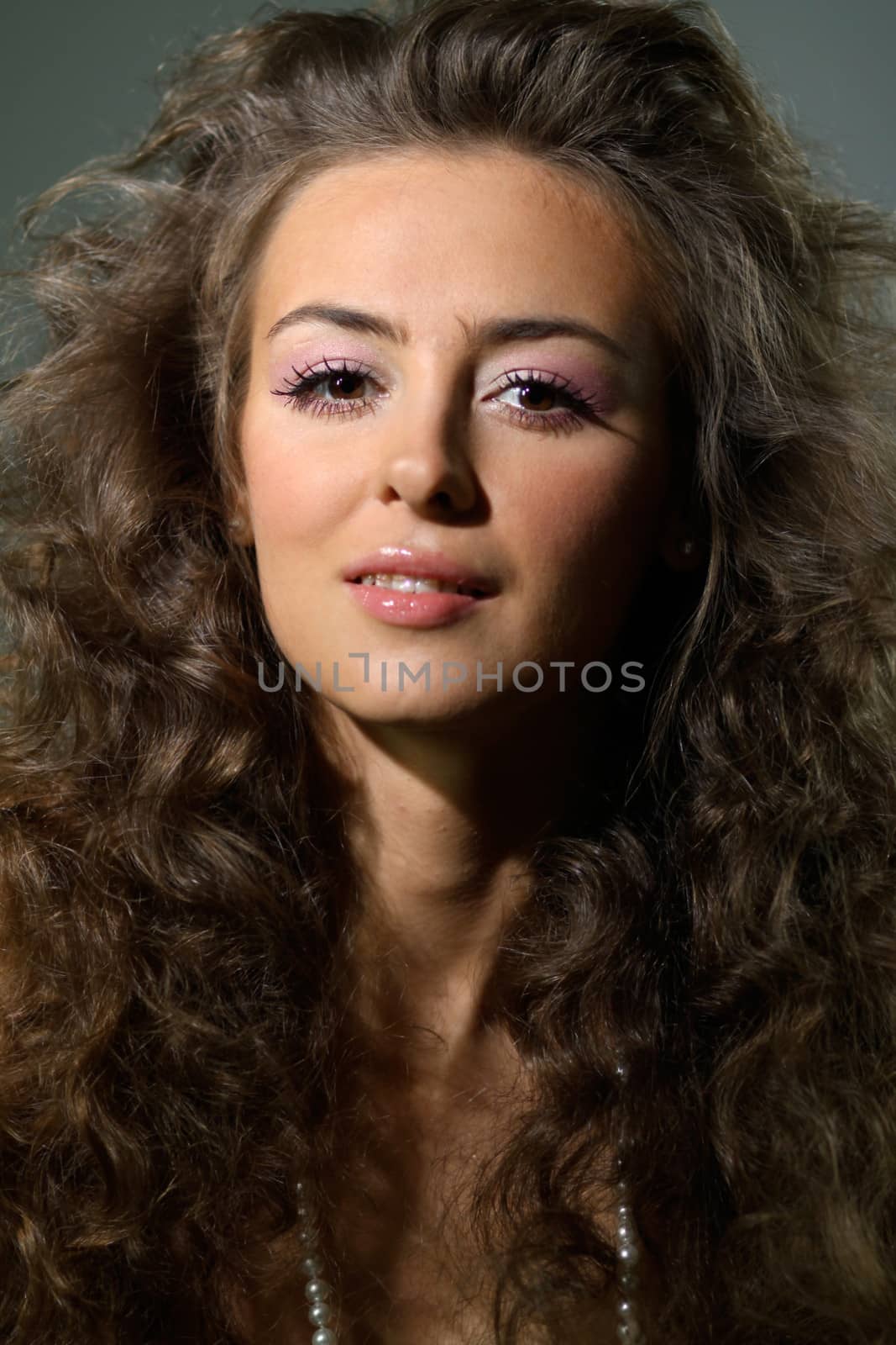 Beautiful young woman in gray background