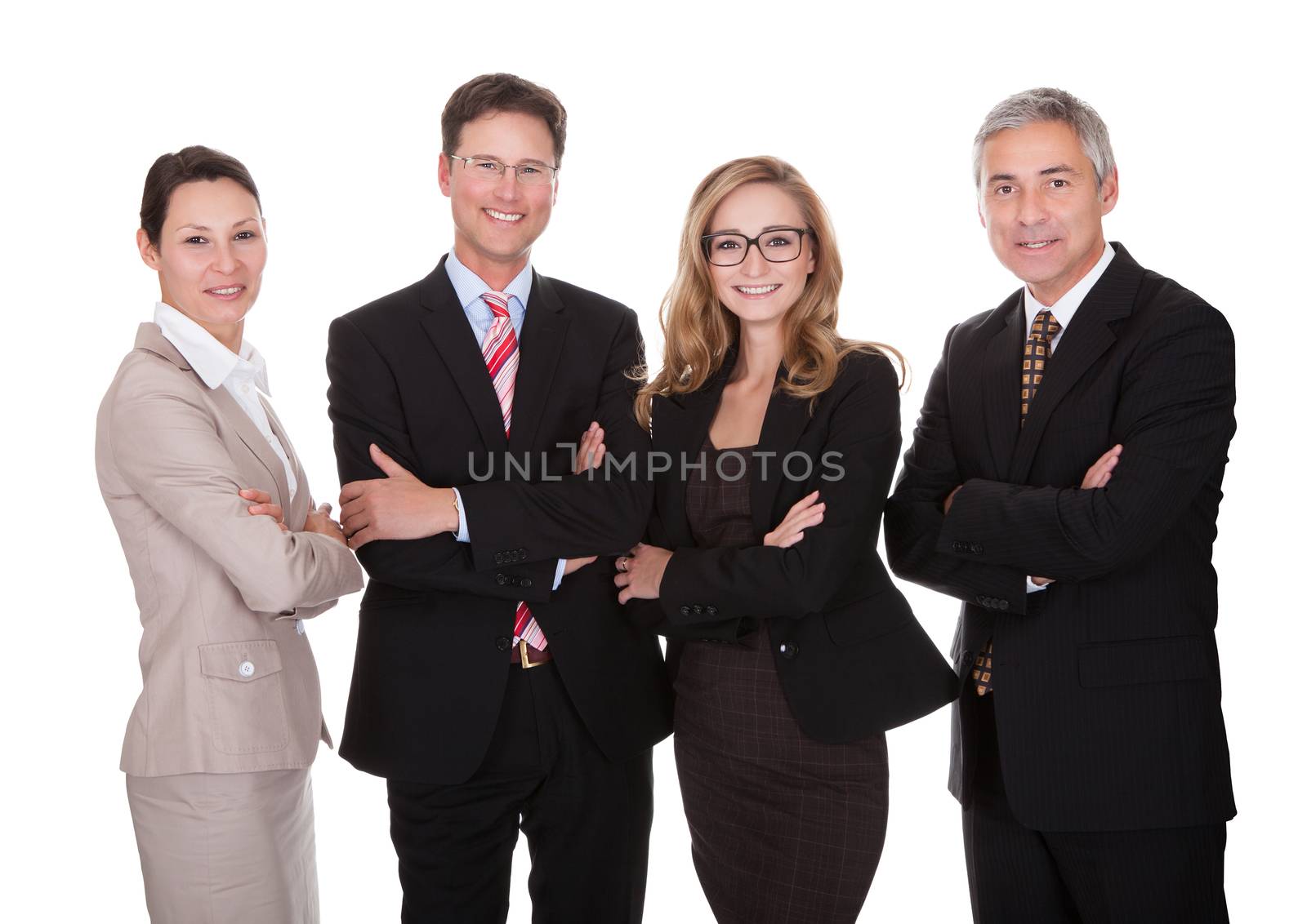 Smiling group of stylish business professionals standing in a row with their arms folded looking at the camera isolated on white