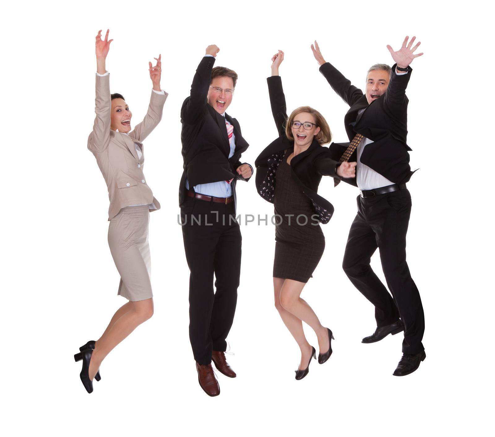 Four diverse professional business partners jumping for joy with their arms raised shouting in jubilation isolated on white