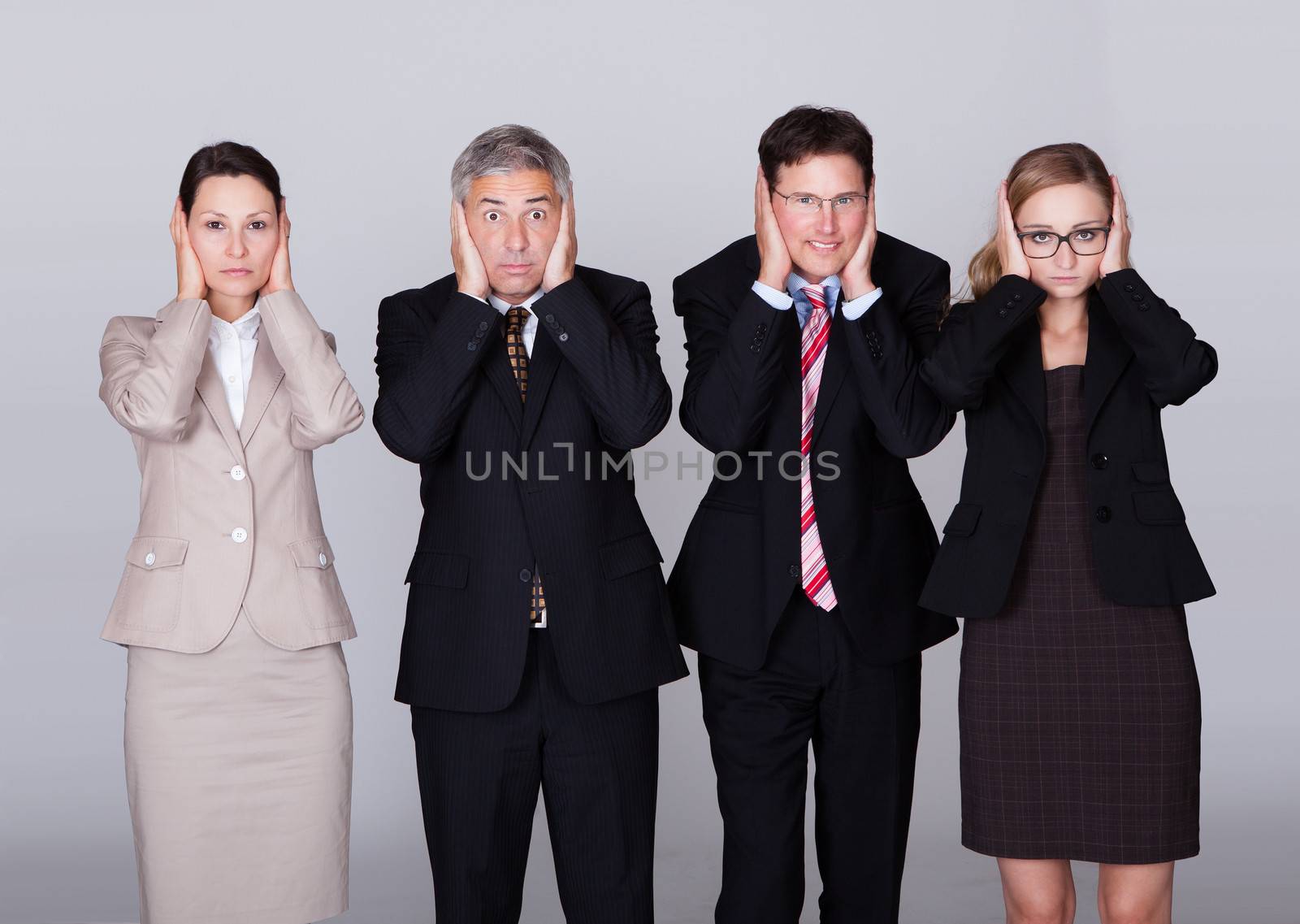 Four businesspeople holding their ears by AndreyPopov