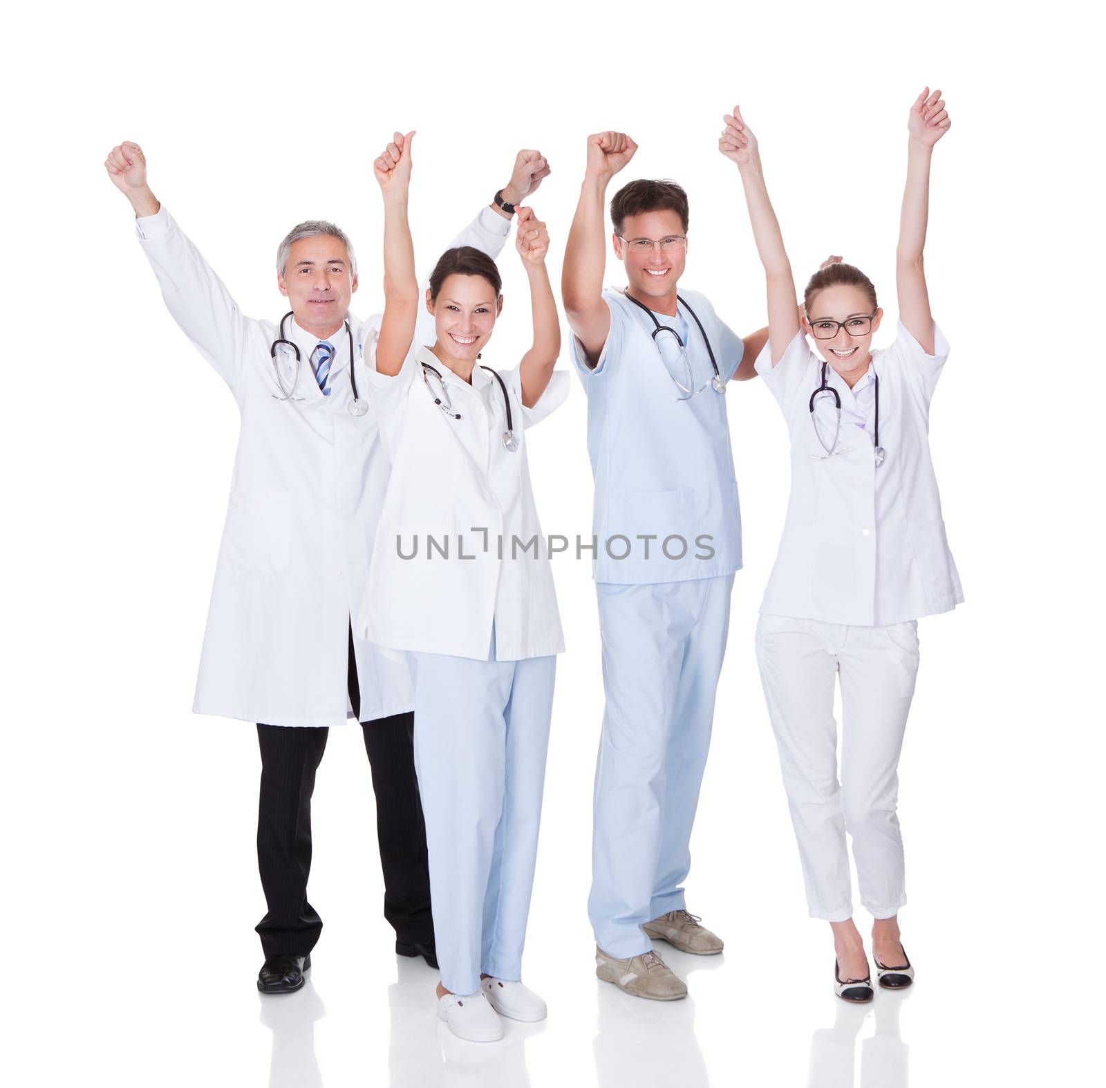 Diverse medical team of male and female doctors and nurses celebrating a successful outcome to a case