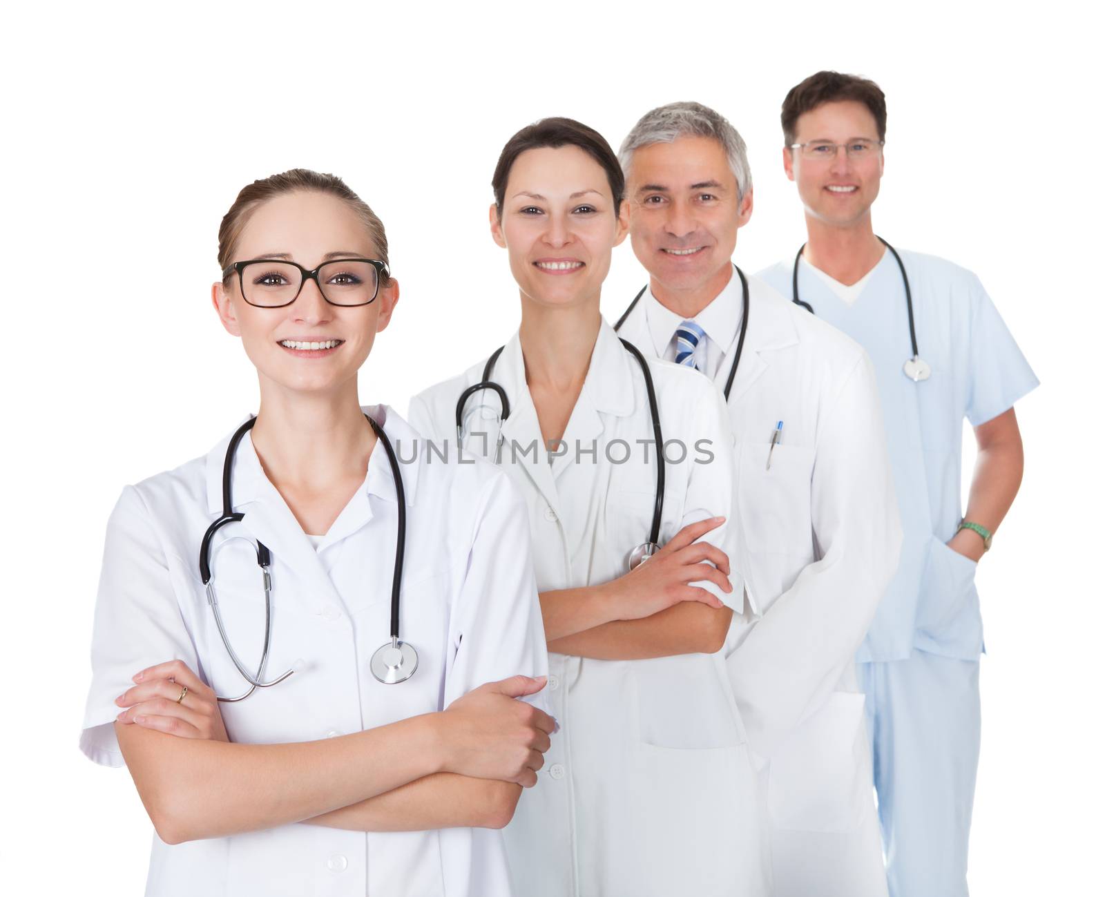 Row of smiling diverse medical doctors and nurses in white uniforms with stethoscopes standing in an oblique receding row isolated on white