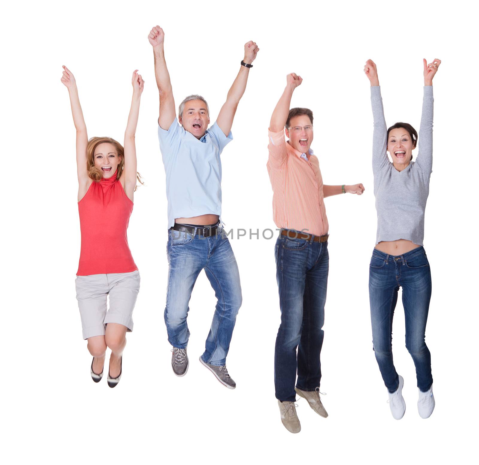 Two happy couples in casual clothing jumping in the air rejoicing with their arms raised isolated on white