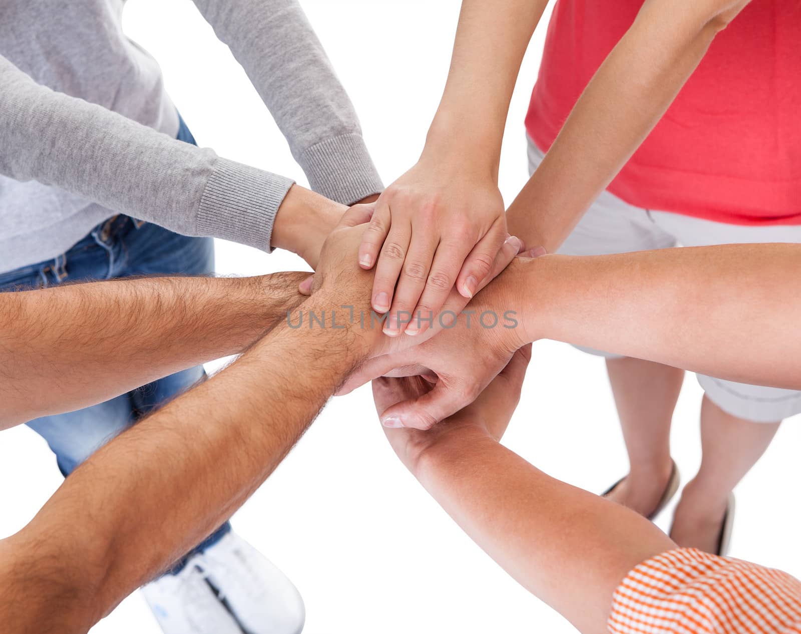 High angle conceptual teamwork and cooperation image of four casual middle-aged friends isolated on white