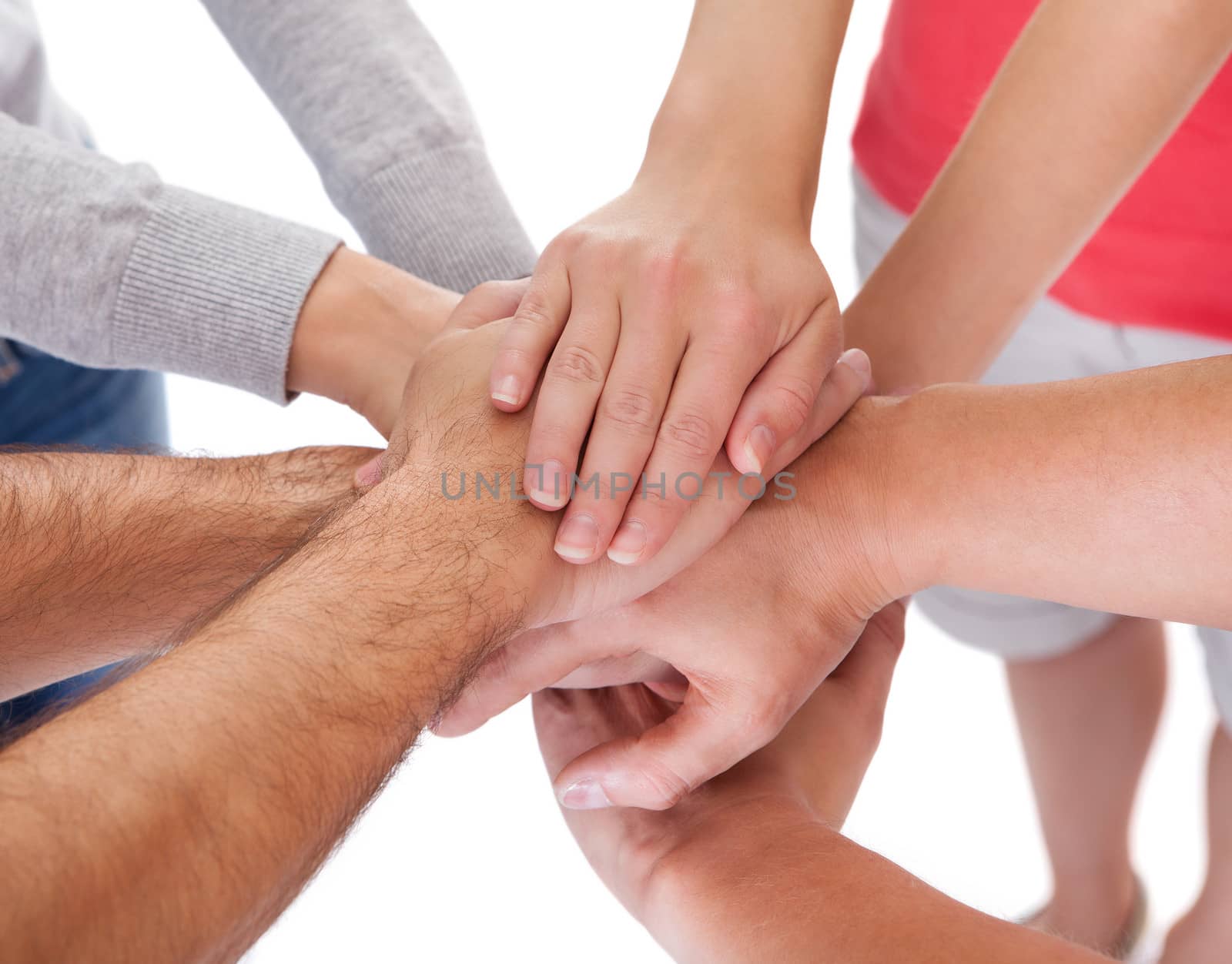 High angle conceptual teamwork and cooperation image of four casual middle-aged friends isolated on white